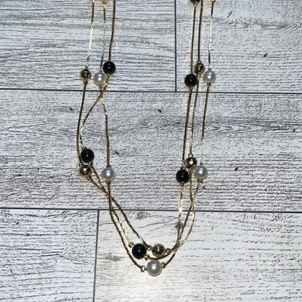 Gold triple chain necklace with white pearl, gold and black beads